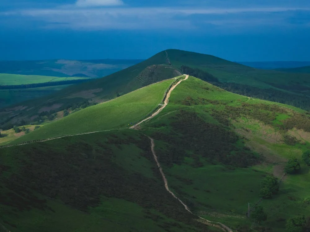 a path over some green hills - represents a meandering career path